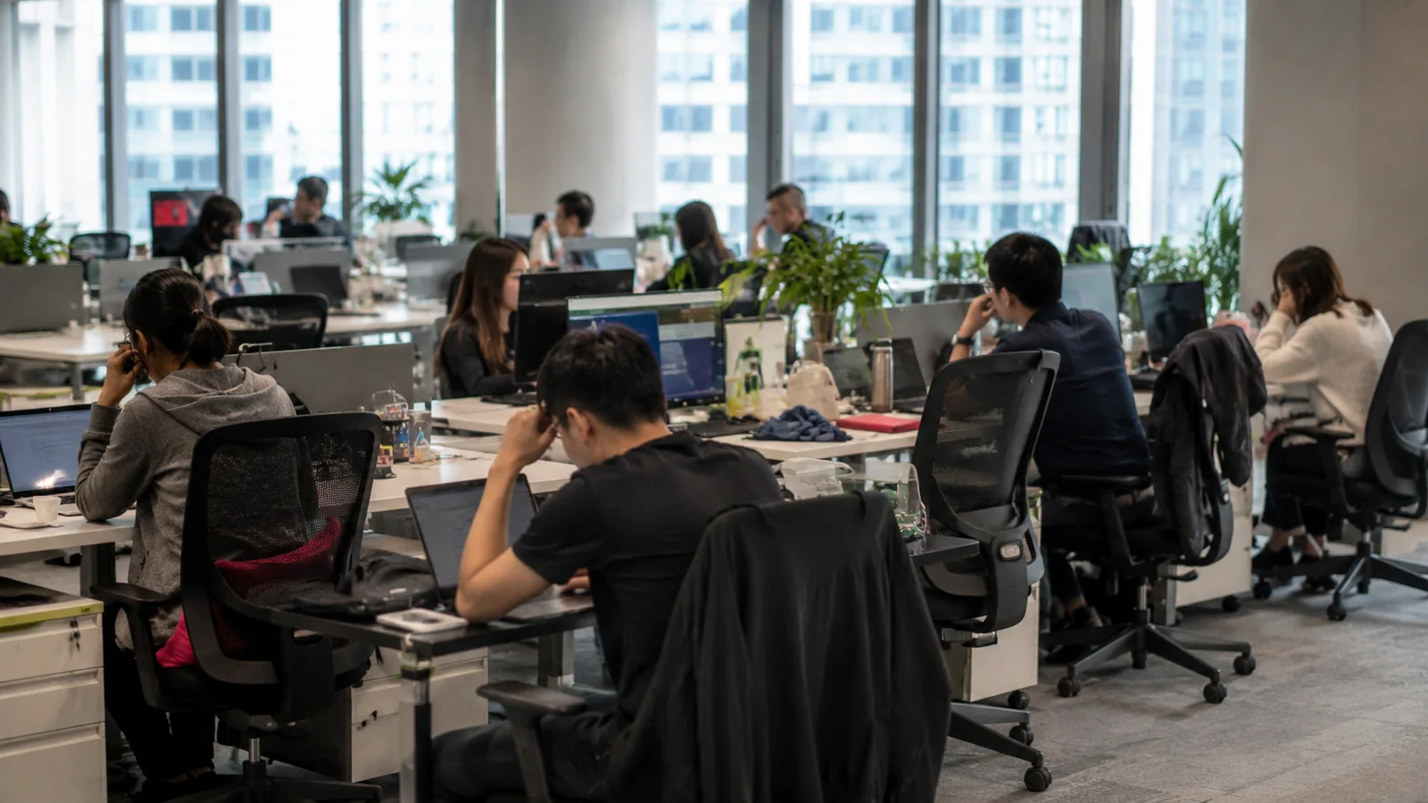 Office workers using poorly adjusted workstations and awkward postures