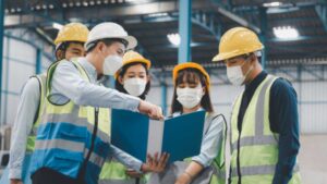 Workplace safety officers reviewing hazards and control measures during an industrial safety risk assessment in Singapore