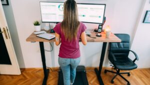 Height-adjustable standing desk setup demonstrating proper workplace ergonomics in Singapore with monitor at eye level and elbows at 90 degrees