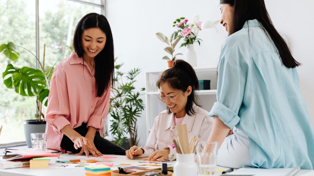 Office team collaborating while standing to boost circulation, energy and focus as part of workplace ergonomics Singapore practices