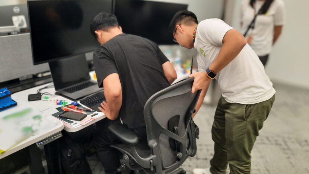 Workplace ergonomics assessment in Singapore with specialist adjusting office chair posture to reduce WMSD risk