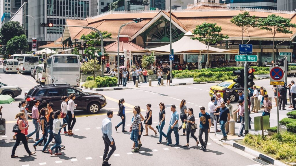 Busy Singapore city scene representing workplace safety statistics, injury risks, and importance of Workplace Safety Officers in improving safety performance