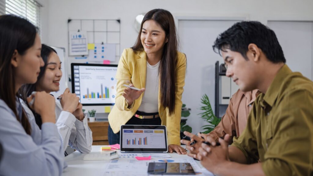 Leadership team discussing plans together in an office meeting, reflecting management engagement and long-term organisational commitment
