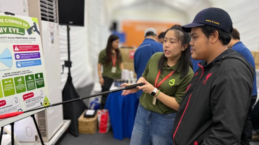 Safety facilitator explaining eye safety and risk awareness to an employee during a workplace health and safety engagement