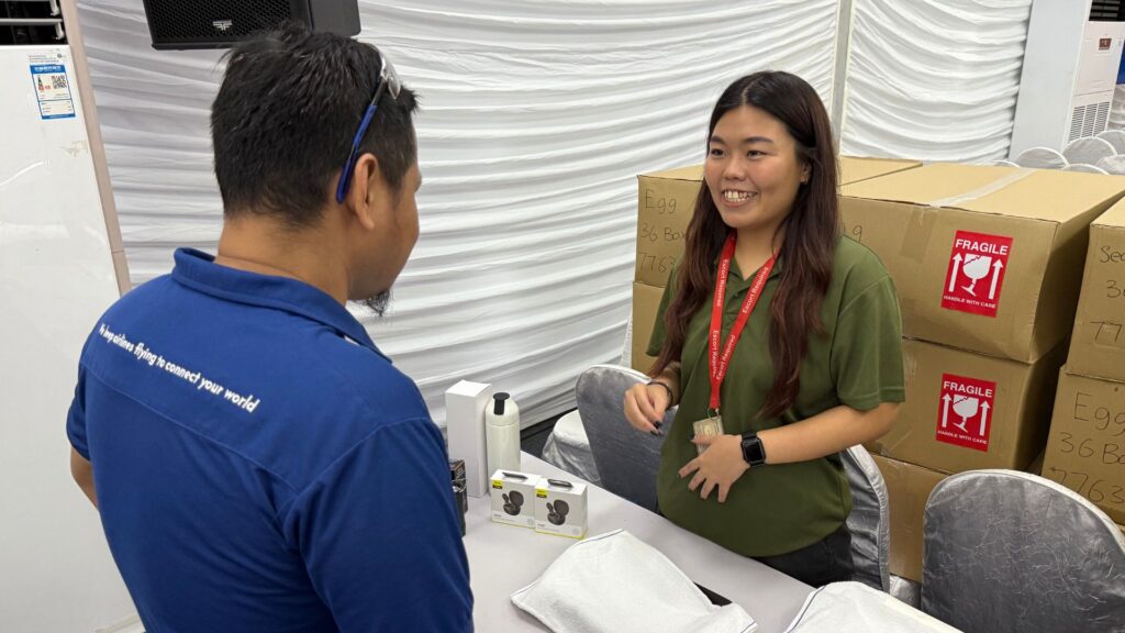 Workplace health facilitator engaging an employee during an on-site wellness or health screening session
