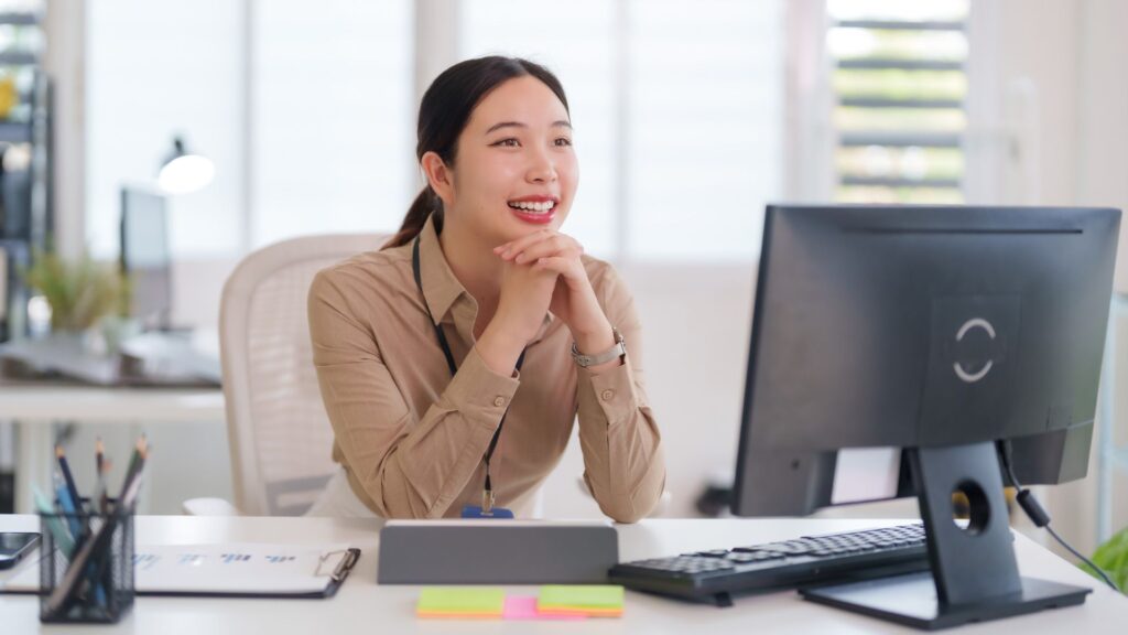 Office employee working comfortably, representing improved well-being and productivity from a strong occupational health and safety program