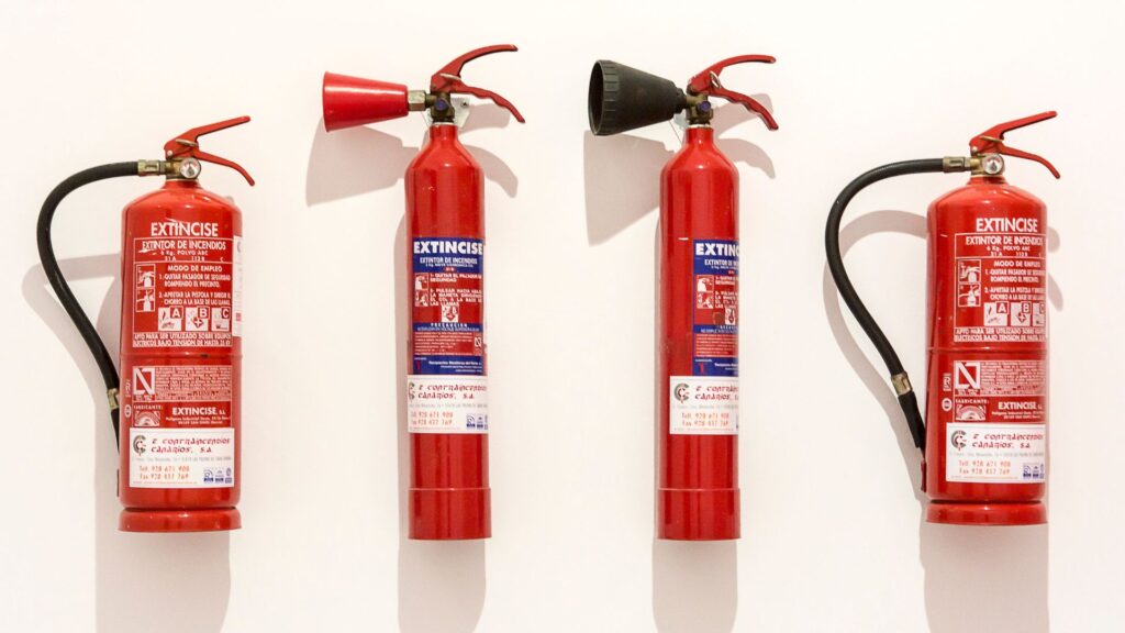 Fire extinguishers installed as part of workplace emergency preparedness under occupational health and safety program Singapore