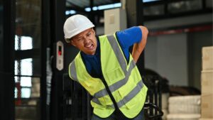 warehouse worker experiencing back pain from ergonomic hazards Singapore workplace