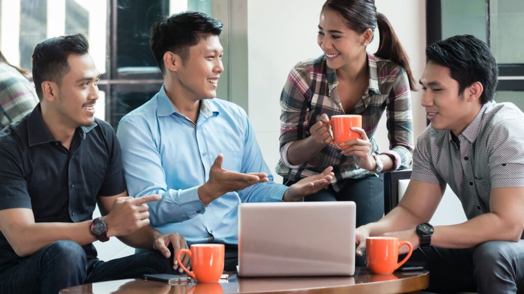 Singapore business owners discussing bizSAFE certification costs and funding options